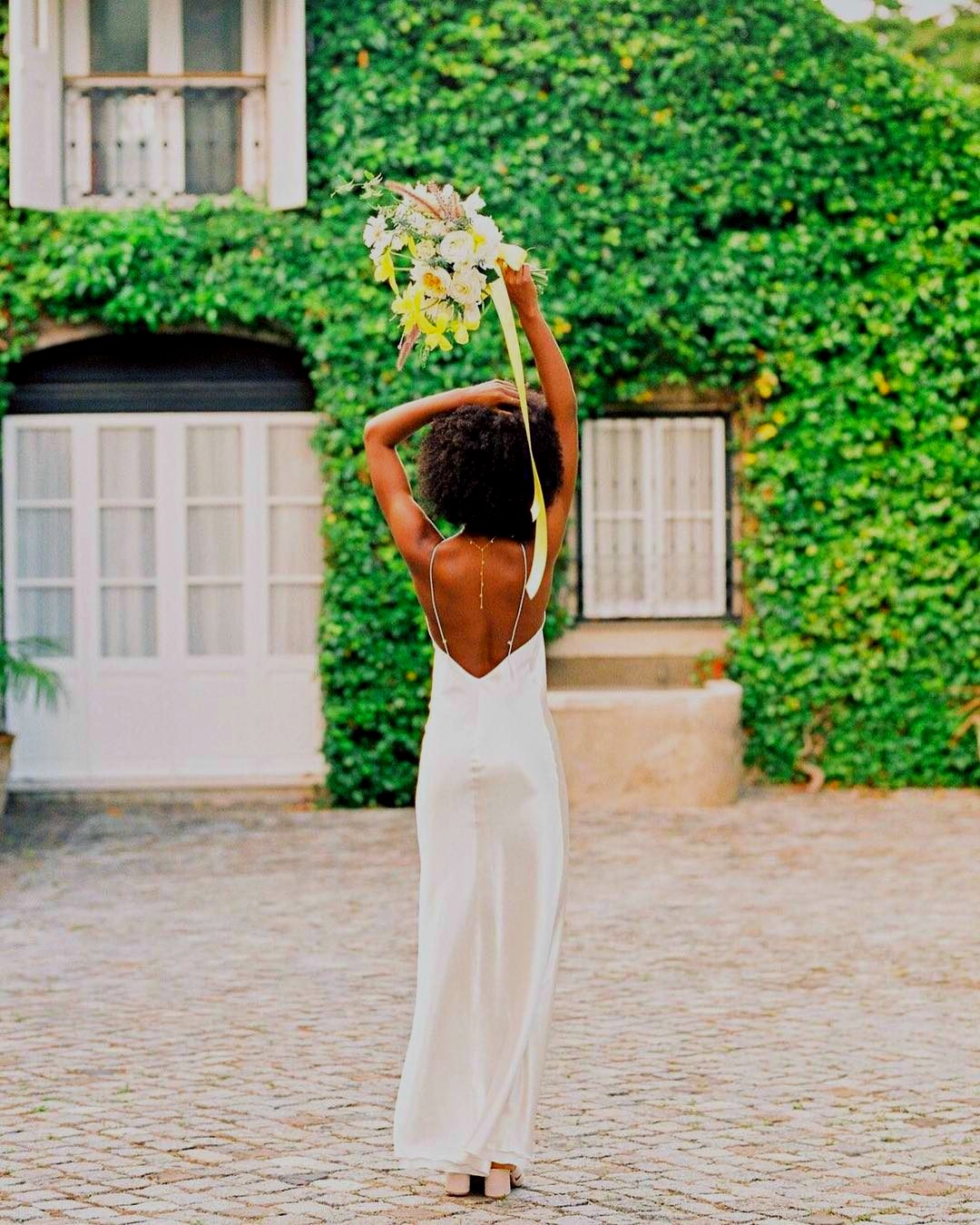 Bride in front of the ivy-covered house